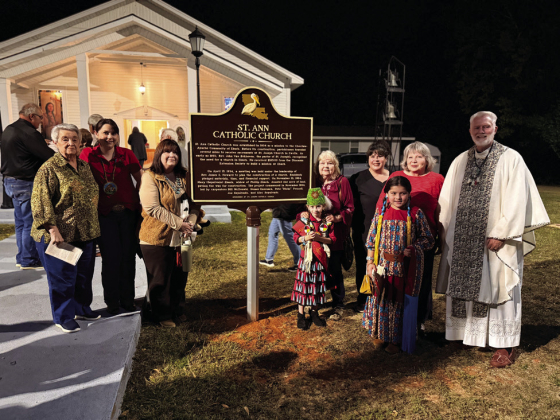 The Rev. Keith Garvin, at right, ispictured with some parishioners of St. Ann’s Catholic Church.