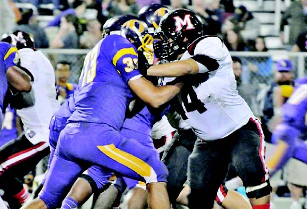 Robert Parrie (44) attempts to fight off Oakdale fullback Timmy Townley (33) during action last Friday night. Parrie and the Many Tigers blanked Townley and the Warriors, 42-0. (Special to the Index/TINA McCORMIC)