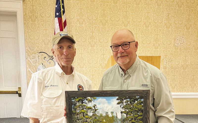 Gary Moore, of Many was the successful bidder on Artist Eddie Pastureau’s original painting titled “Cruising the Swamp with Bandit”.