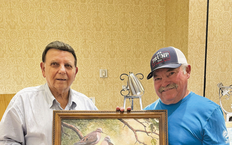 Wildlife Artist Don Edwards presents Larry Rice of Many with his canvas giclee’ “New Home – Mourning Dove” as the successful bidder on this piece.
