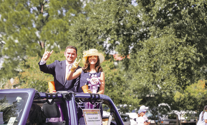 Christopher Richard, left, and Brooke Straight ride in Northwestern State University’s 2025 Homecoming Parade as students. Both returned to their alma mater this year to begin professional careers serving students and the university community.