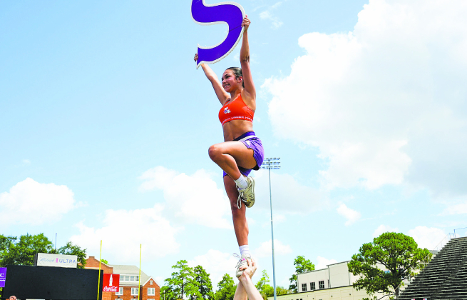 NSU Cheer member Sofia Albores performs a stunt during practice as the team prepares for the fall football season.