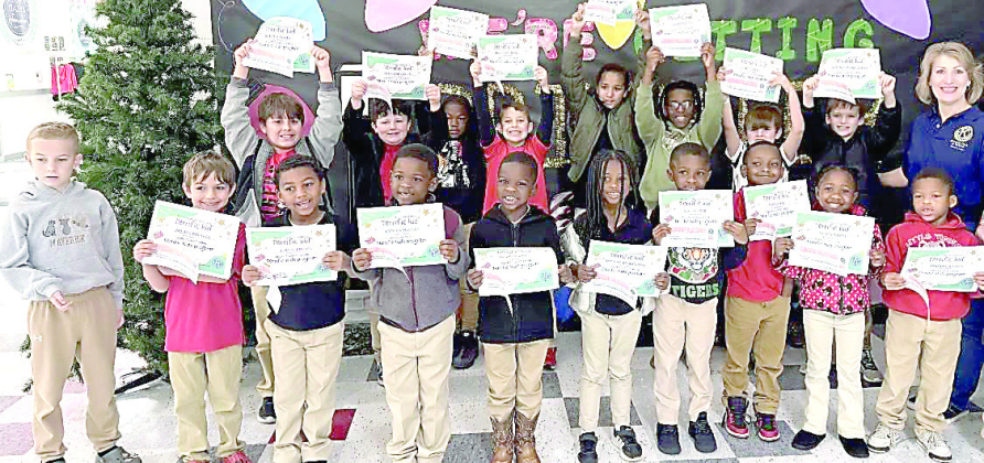 Many Elementary students show off their Terrific Kid certificates with club president Dawn Leone in December.