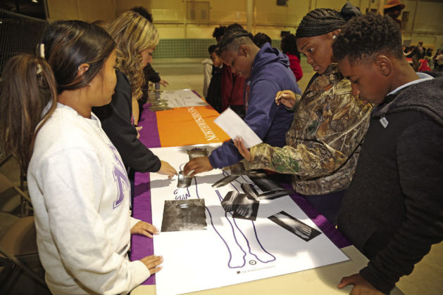 Students Jayden Tompkins, Jayda Cooper and Kedrick Francisco of Riverside Elementary in Avoyelles Parish placed bone x rays in the proper places guided by student volunteers from Northwestern State’s School of Allied Health during Rural STEM Day Feb. 20
