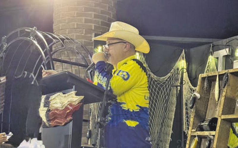Auctioneer Kevin McDonald gets the bids going at the TBLA Bass Unlimited Auction.