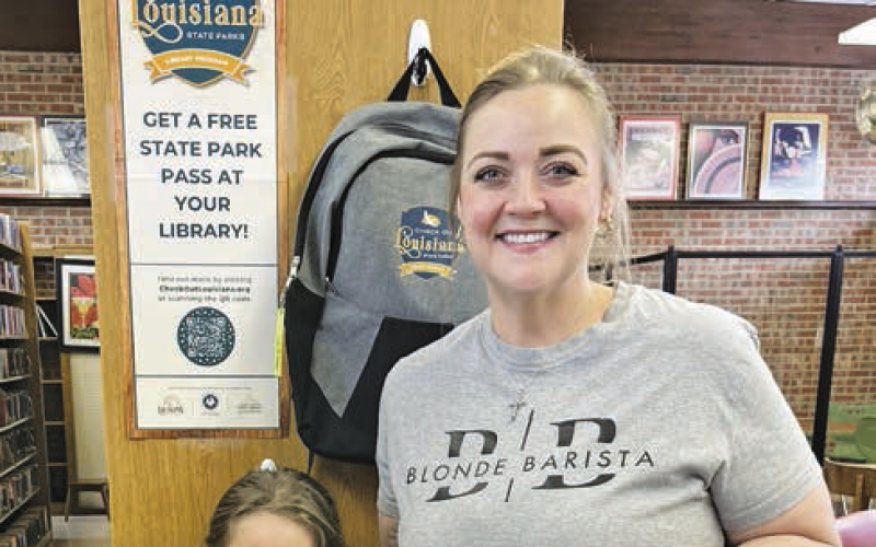 Charli Thigpen and daughter Anna are the first library patrons to check out their state park pass and backpack.