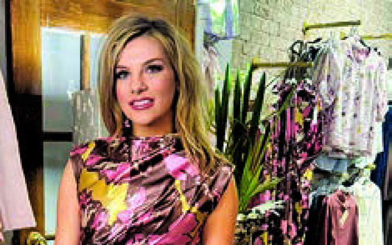 Grace Manasco, owner of Good Gracious, shows off one of the many outfits available in the local business.
