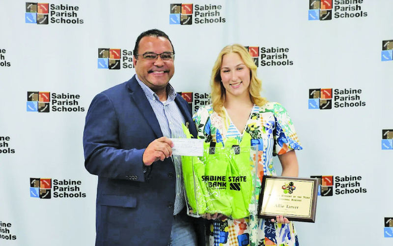 Chris Sylvia, left, is shown presenting a scholarship to Allie Tarver, 12th Grade Student of the Year