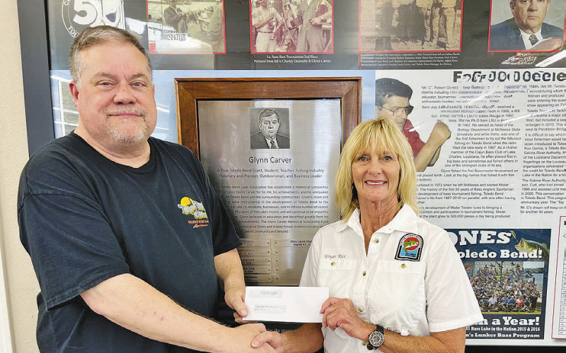 Curt Carver of Toledo Town &amp;amp; Tackle presents a check to TBLA President Ginger Rice to help fund the Glynn Carver Memorial Scholarship.