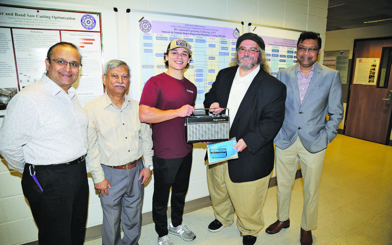 Engineering Technology student Hayden Alberes of Pierre Part repaired a 1960s Telefunken shortwave radio that belonged to the father of NSU Professor of History Dr. Charles Pellegrin. From left are ET faculty Dr. Nabin Sapkota, Dr. Rafiqul Islam, Alberes, Pellegrin, and Dr. Shahriar Hossain, department head.