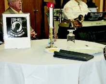 A table for one was set for those POWs and MIAs not able to attend the annual Veterans Day service held at the Disable American Veterans building near Toledo Town.