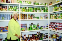 Beverly Sumner of the Sabine Council on Aging at Legacy House is shown with some of the staples in the food pantry.