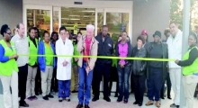 Mayor G.J. “Pie” Martinez cuts the ribbon to declare the new Walmart Neighborhood Market open to the public on Jan. 21. He is surrounded by Walmart employees, town council members, and Police Chief Daniel Thoma