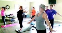 Vickie Holbrook, at right, teaches one of her early-morning yoga classes. She currently teaches the ancient form of exercise and well being at Josh Crow’s new physical therapy office and in private sessions.