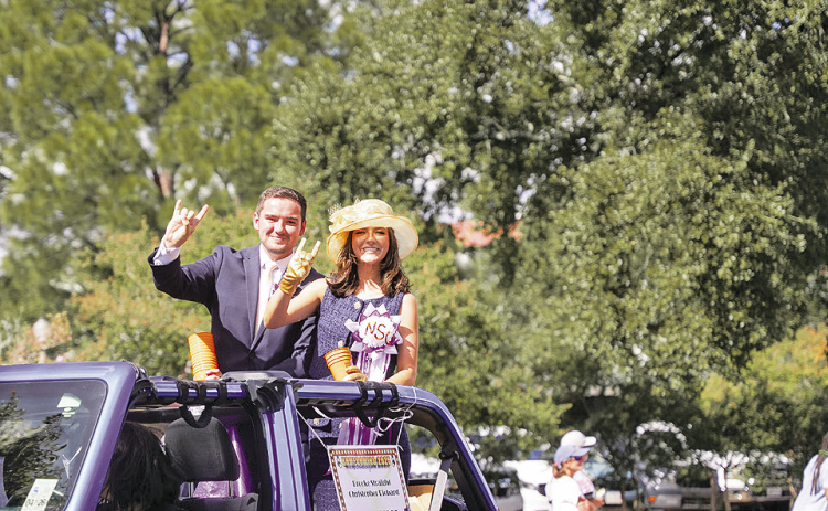 Christopher Richard, left, and Brooke Straight ride in Northwestern State University’s 2025 Homecoming Parade as students. Both returned to their alma mater this year to begin professional careers serving students and the university community.