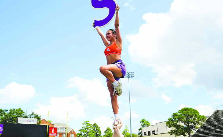 NSU Cheer member Sofia Albores performs a stunt during practice as the team prepares for the fall football season.