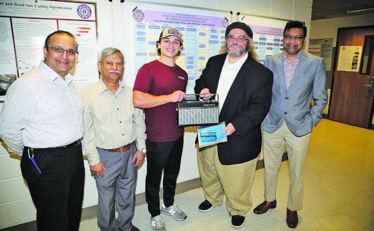 Engineering Technology student Hayden Alberes of Pierre Part repaired a 1960s Telefunken shortwave radio that belonged to the father of NSU Professor of History Dr. Charles Pellegrin. From left are ET faculty Dr. Nabin Sapkota, Dr. Rafiqul Islam, Alberes, Pellegrin, and Dr. Shahriar Hossain, department head.